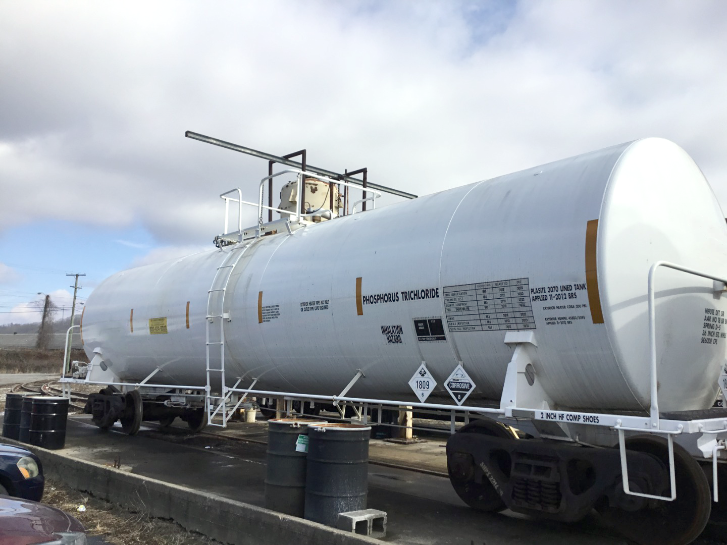 A wide view of a rail tank car positioned on a railroad track. 